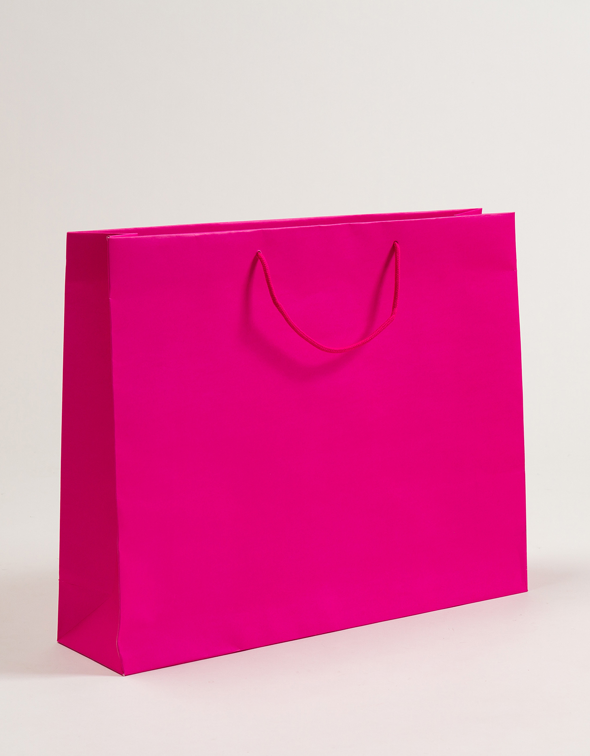 Produktbild Papiertragetaschen POP mit Stoffkordel pink in der Größe 54 x 14 x 44 + 5 cm