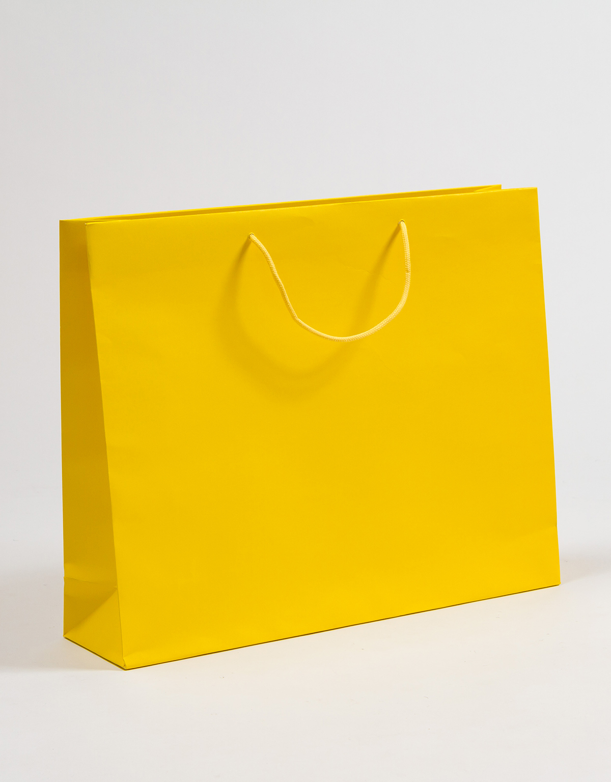 Produktbild Papiertragetaschen POP mit Baumwollkordeln gelb in der Größe 54 x 14 x 44 + 5 cm